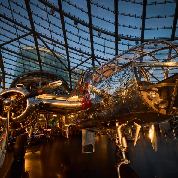 Interior view of Hangar-7 showing its glass-and-steel architecture and an aircraft in the exhibition
