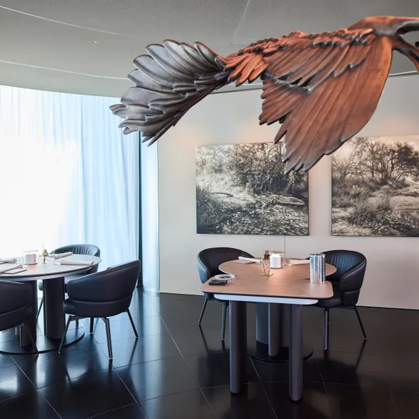 inside area of Restaurant Ikarus with Ikarus sculpture and painting