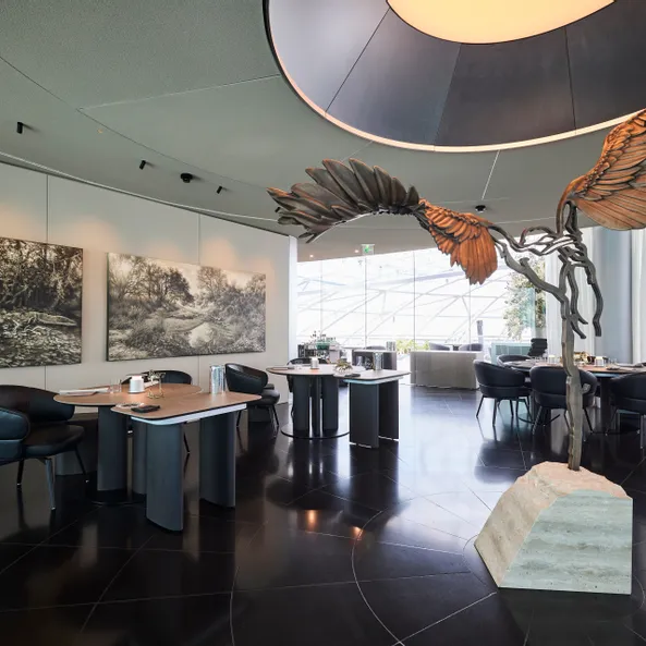 inside area of Restaurant Ikarus with Ikarus sculpture and painting