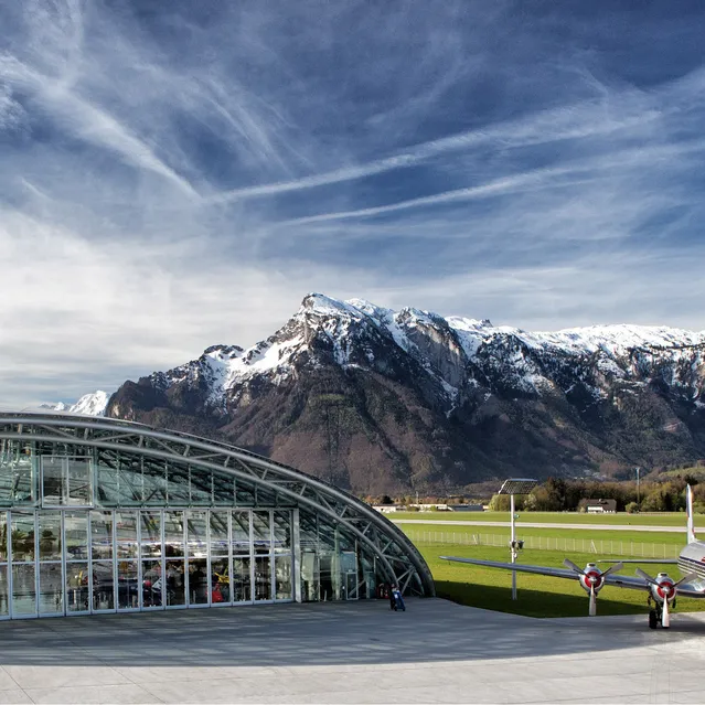 Outside shot of Hangar-7 with the Douglas DC-6 on the airfield and the Untersberg in the background