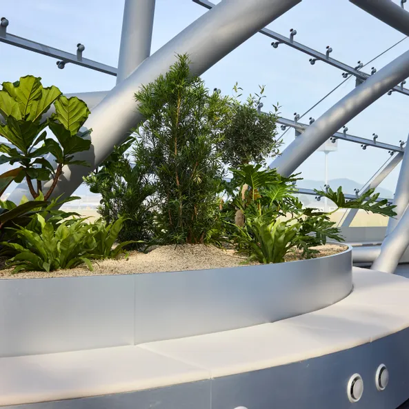 Interior view of Hangar-7 showing its glass-and-steel architecture, seating arrangements and plants