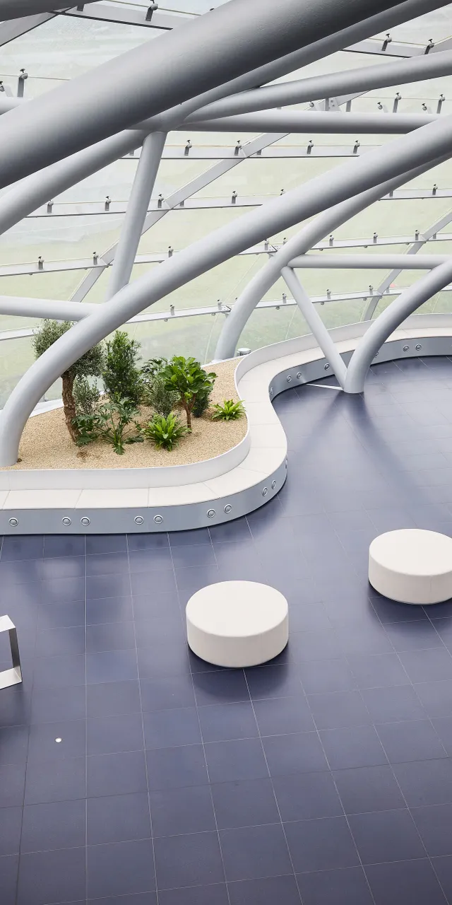 Interior view of Hangar-7 showing its glass-and-steel architecture, seating arrangements and plants